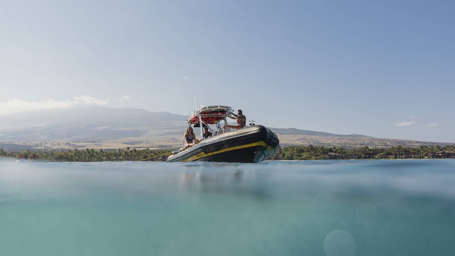 A group of people enjoying the Coastal Aquatic Adventure on our Ribcraft boat off the shores of Hualalai