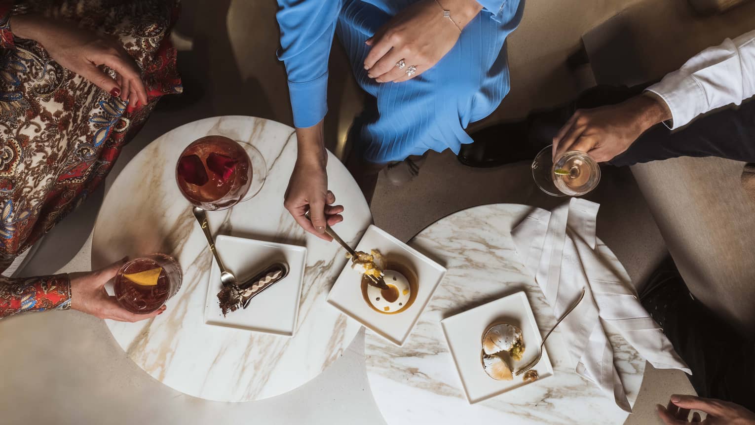 Aerial shot of guests enjoying cocktails and dessert