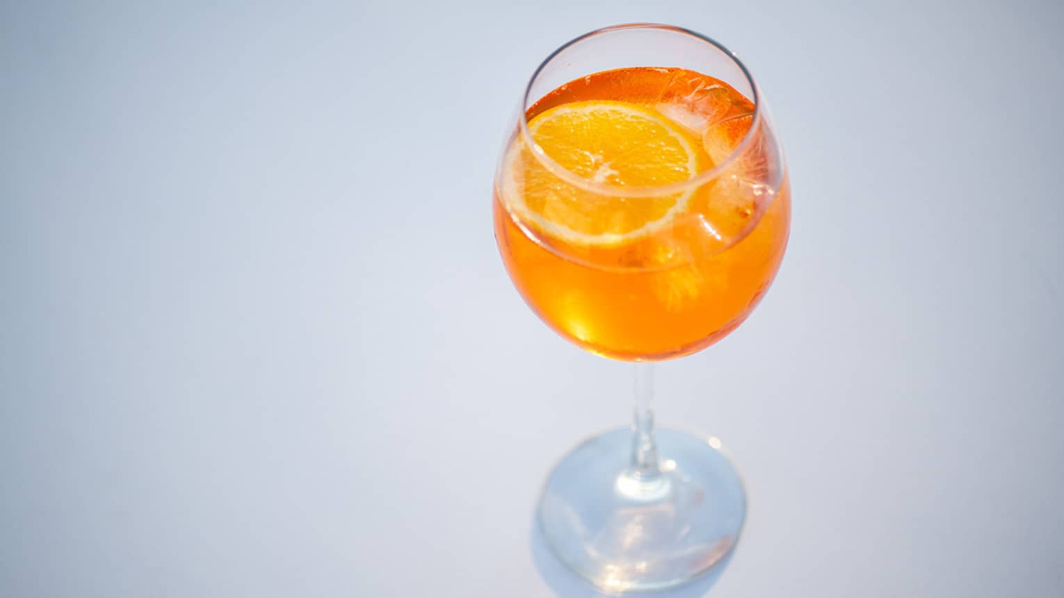 An orange aperol spritz in a crystal glass.