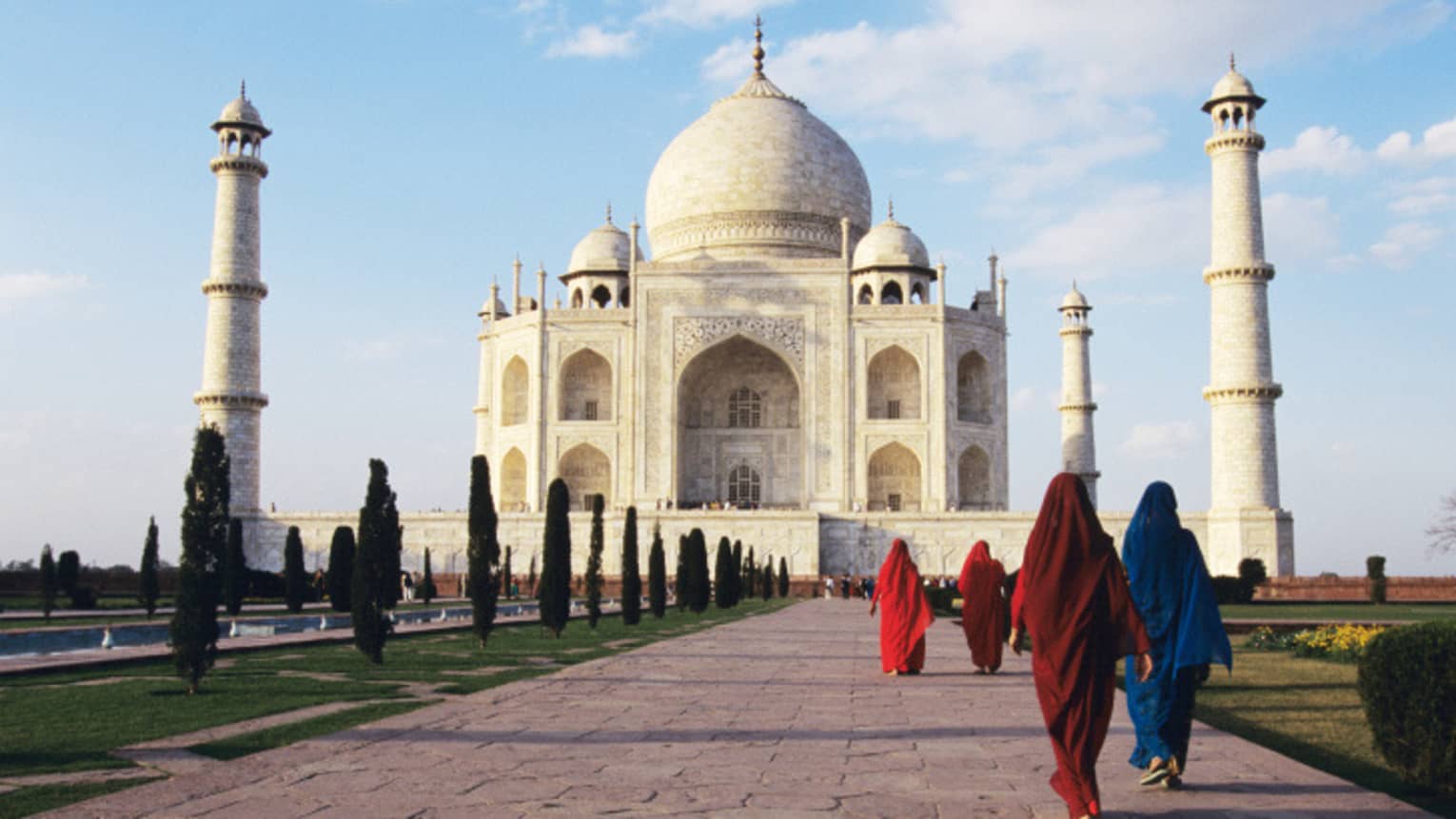 People walk along path leading to Taj Mahal building