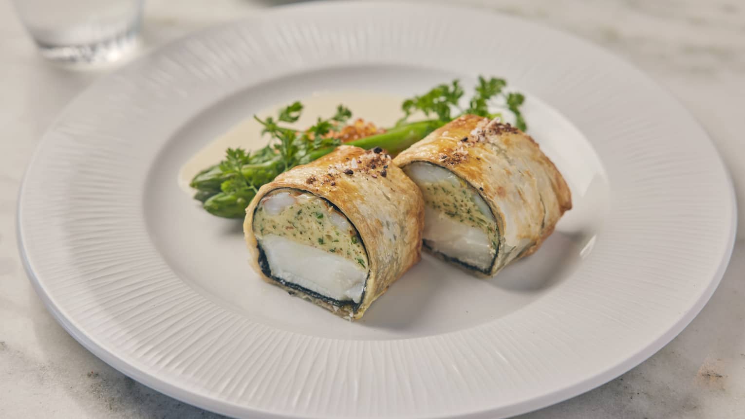 Fish wrapped in pastry with a filling.