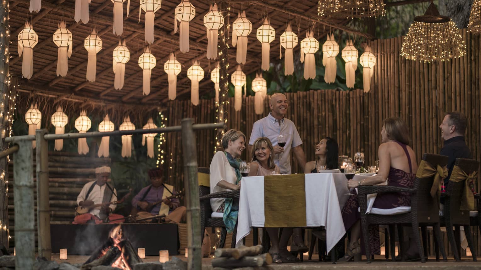 Elephant Camp Dinner, smiling group of diners unders rows of paper lanterns