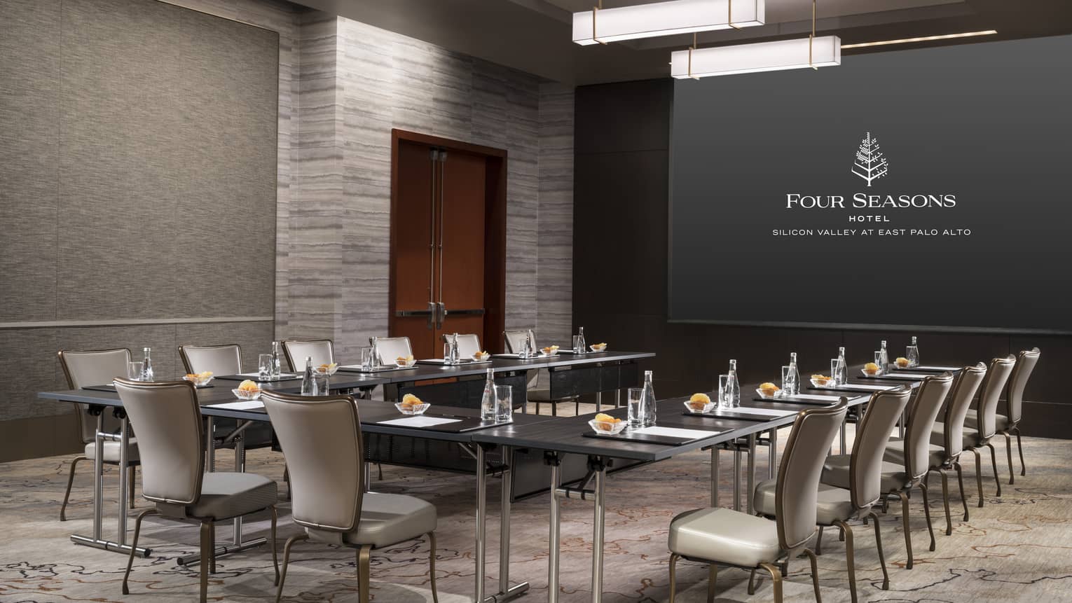 Generation meeting room with modular boardroom table facing screen