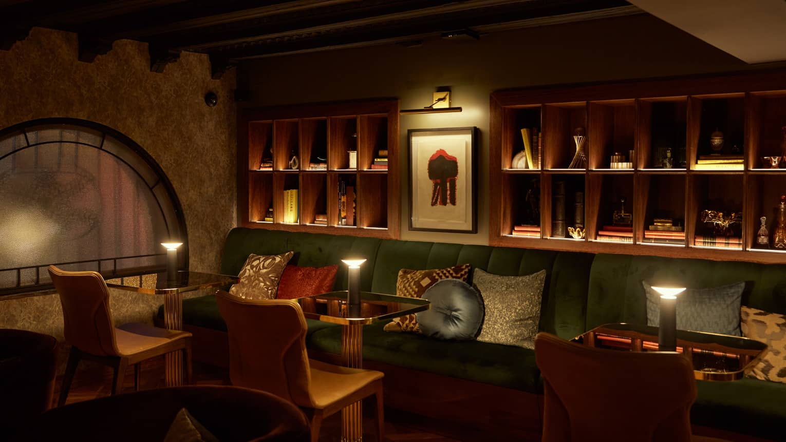 A dimly lit lounge with cushioned benches.