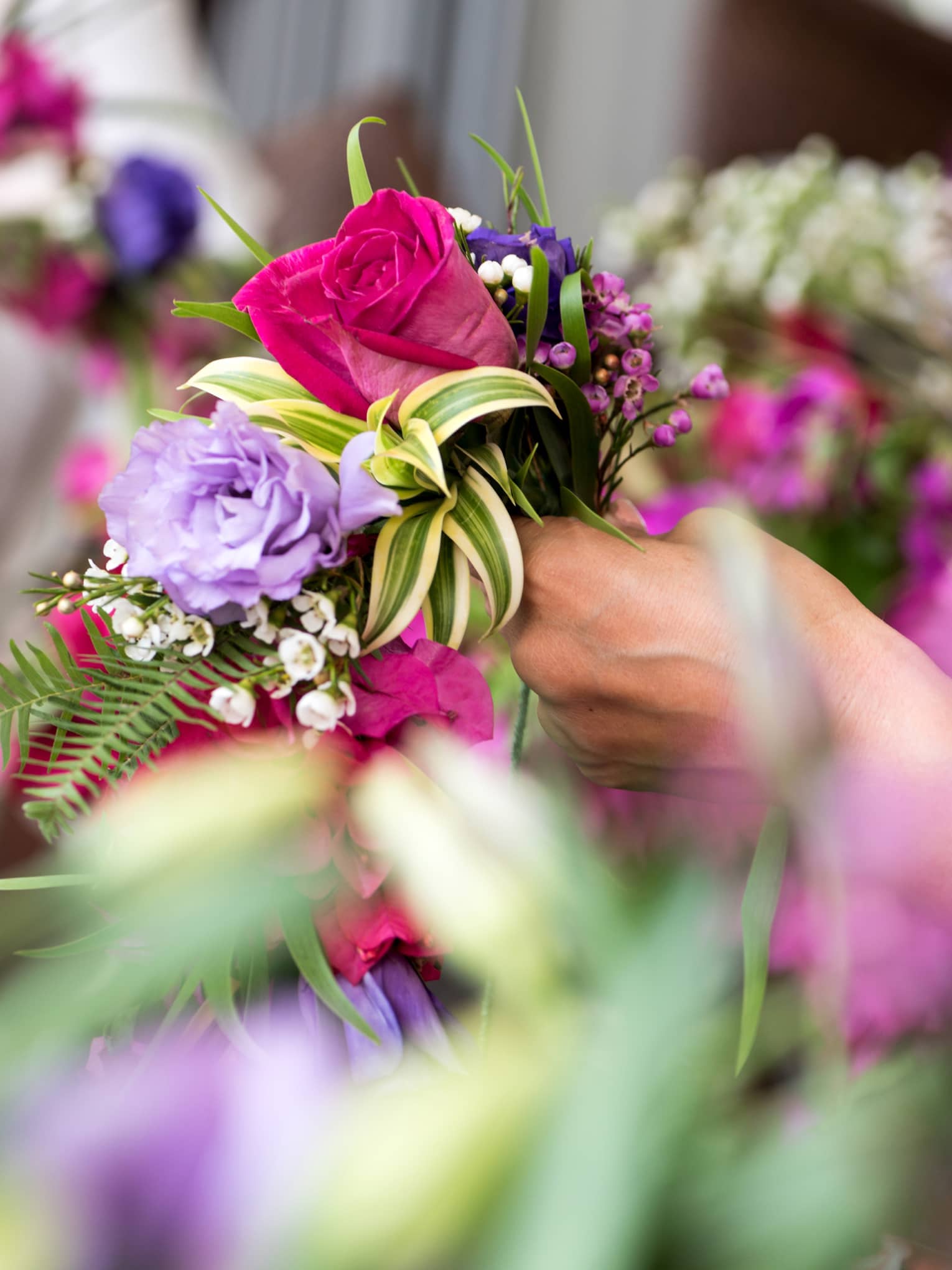 Lei making with bright flowers