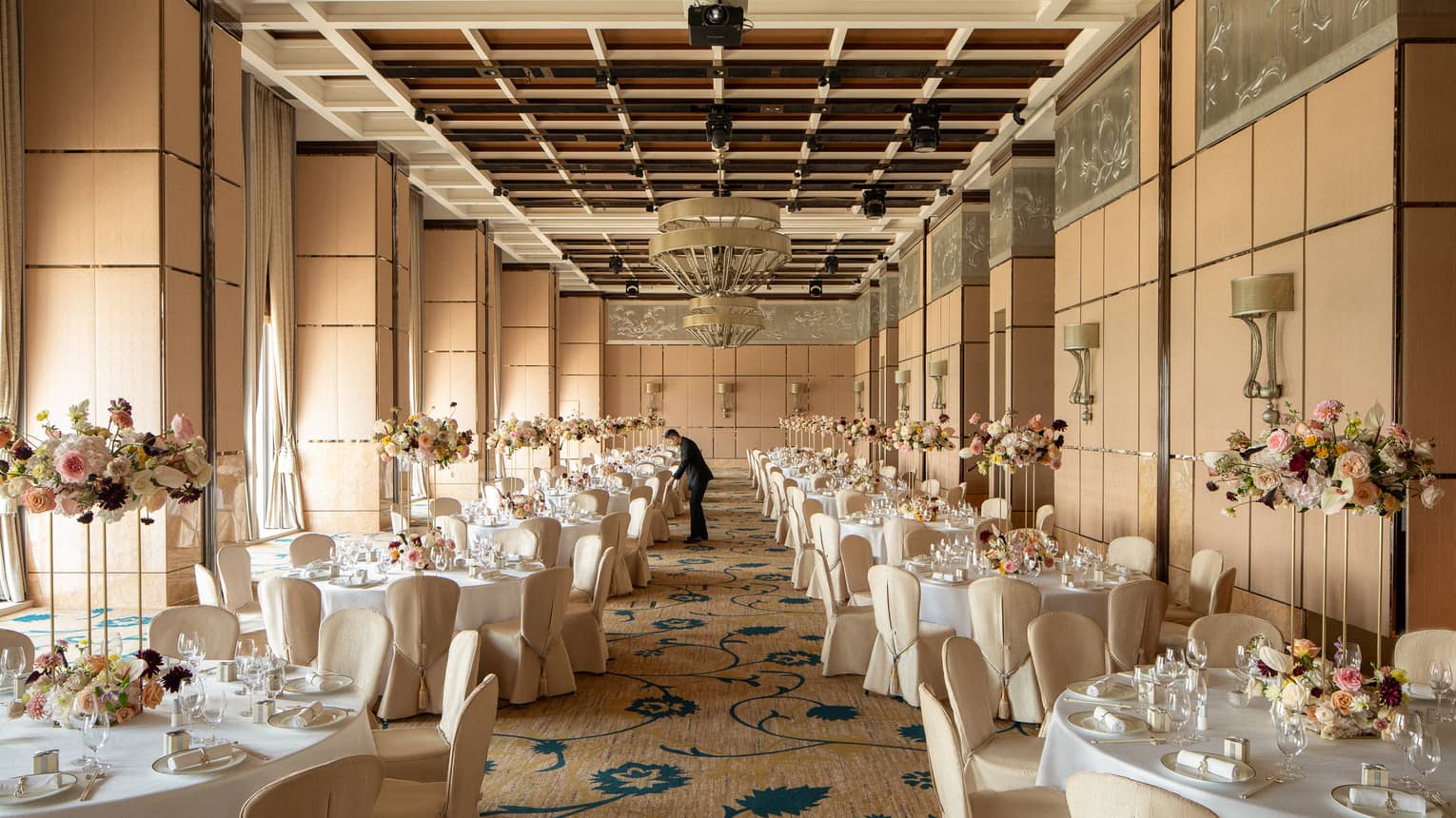 Indoor hotel ballroom set for wedding banquet