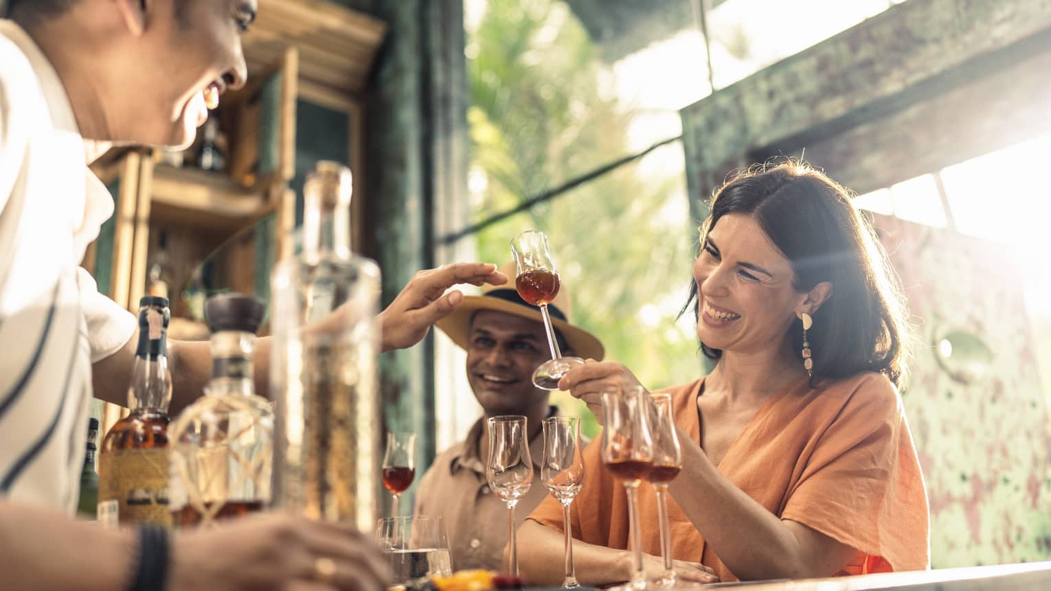 Smiling woman enjoys rum tasting at Rum Vault