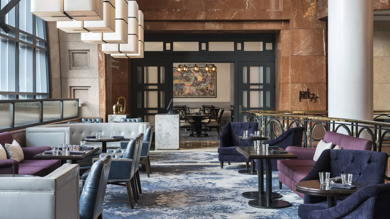 Park 75 modern dining room with velvet lounge chairs, leather banquettes, tall pillar 