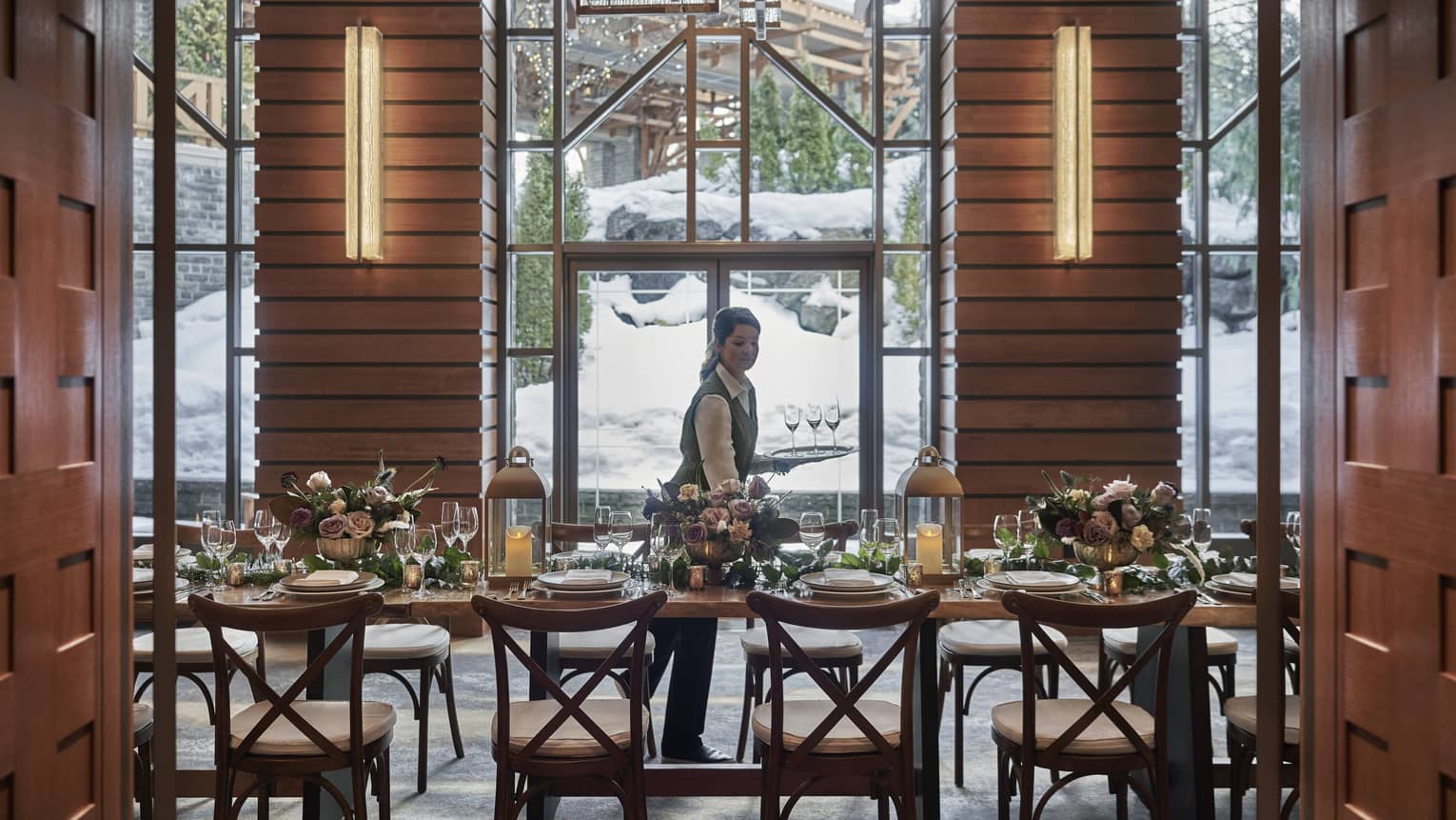 Hotel staff sets dining tables in Harmony Foyer event room