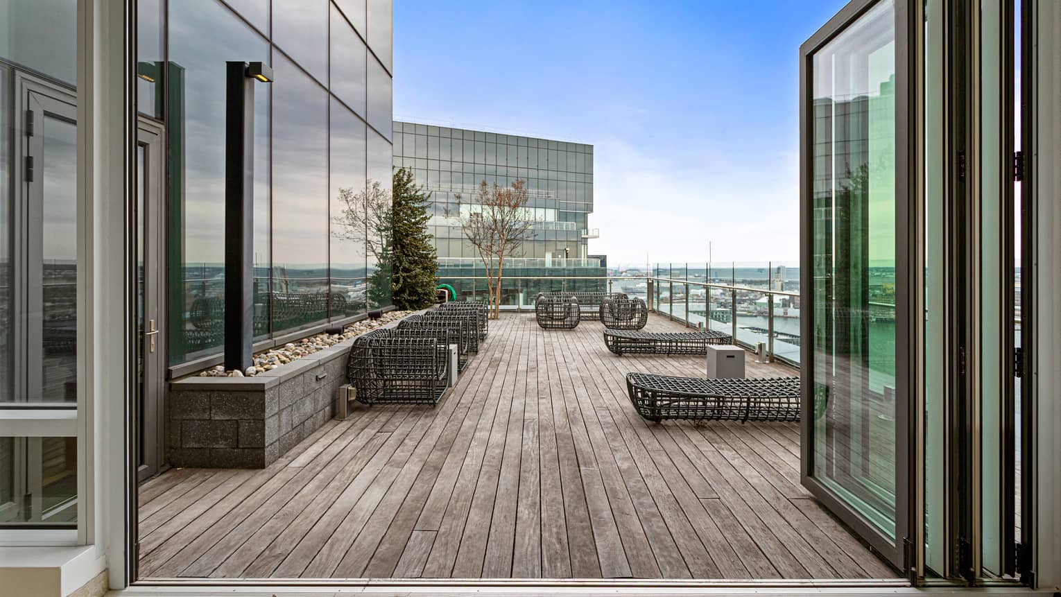 Entrance to private rooftop balcony featuring lounge chairs