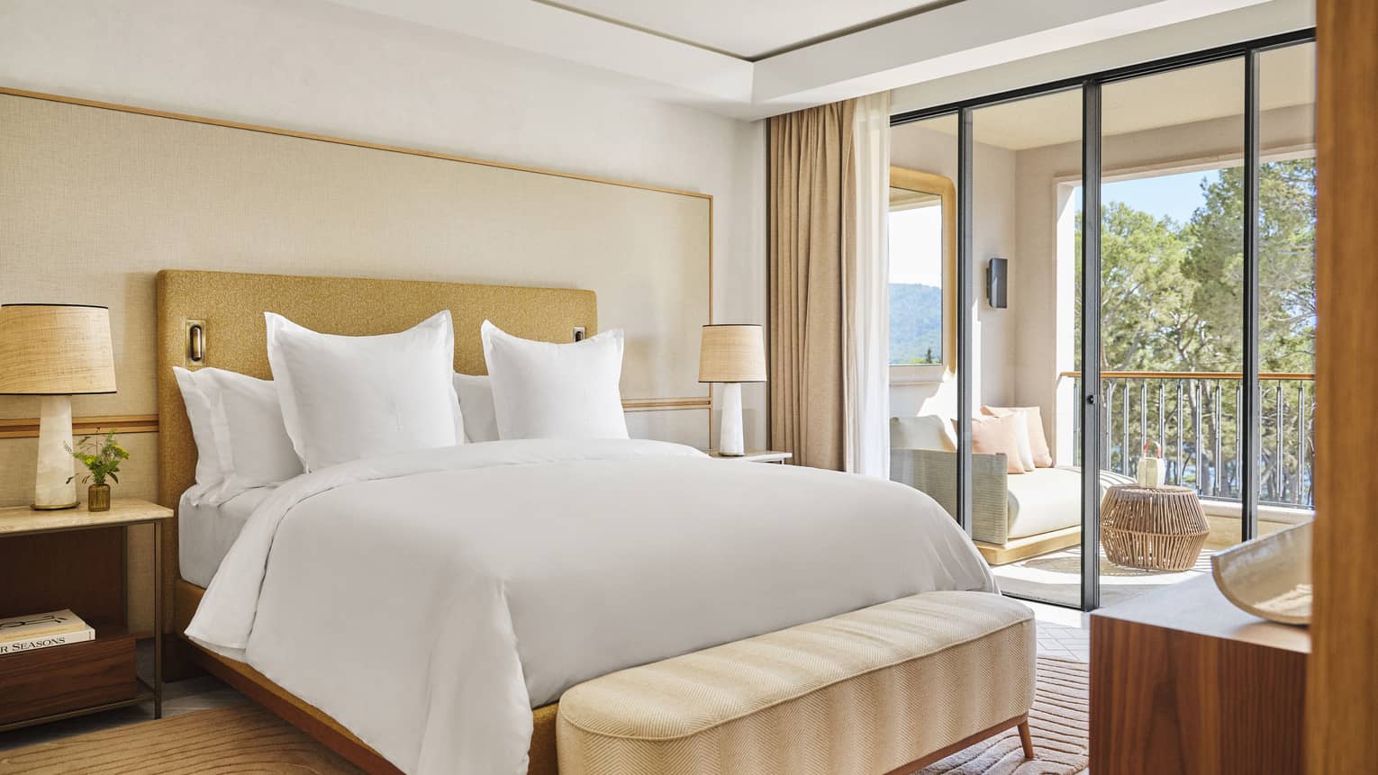 Luxury resort suite bedroom with king bed and walk-out pine-view balcony at Four Seasons Resort Mallorca