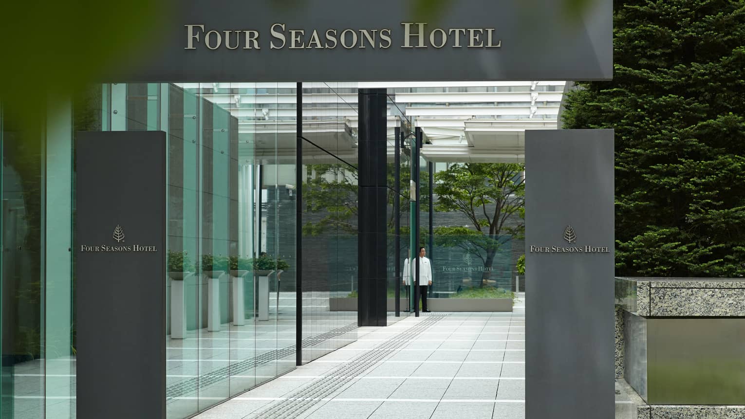 Four Seasons Hotel Tokyo at Marunouchi grey sign over glass entrance