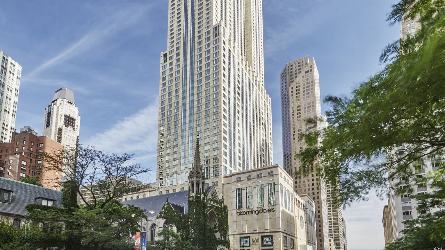 Chicago street exterior on sunny day with Bloomingdales store at base of tall white tower