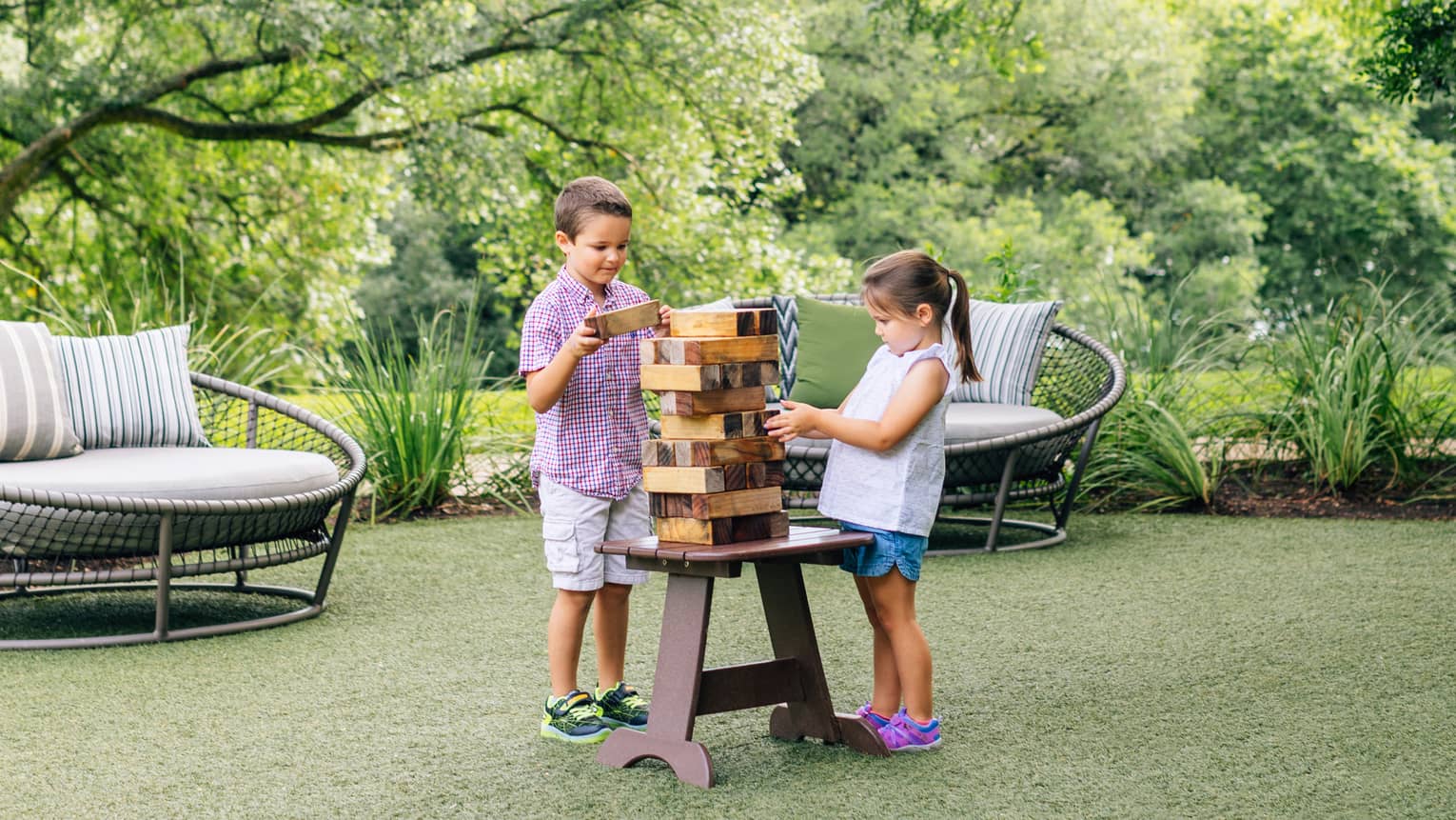 Two small children playing with wooden blocks.