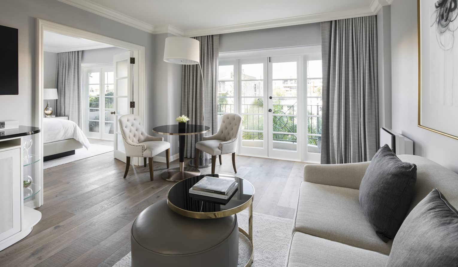 Deluxe Balcony Wellness Room bright living room sofa, table by balcony doors, French doors to bedroom