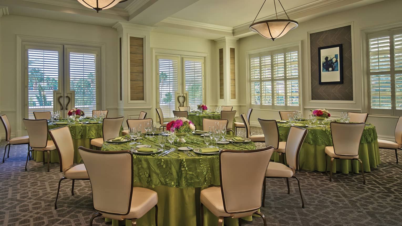 Mesquite Room with small round dining tables with green linens 