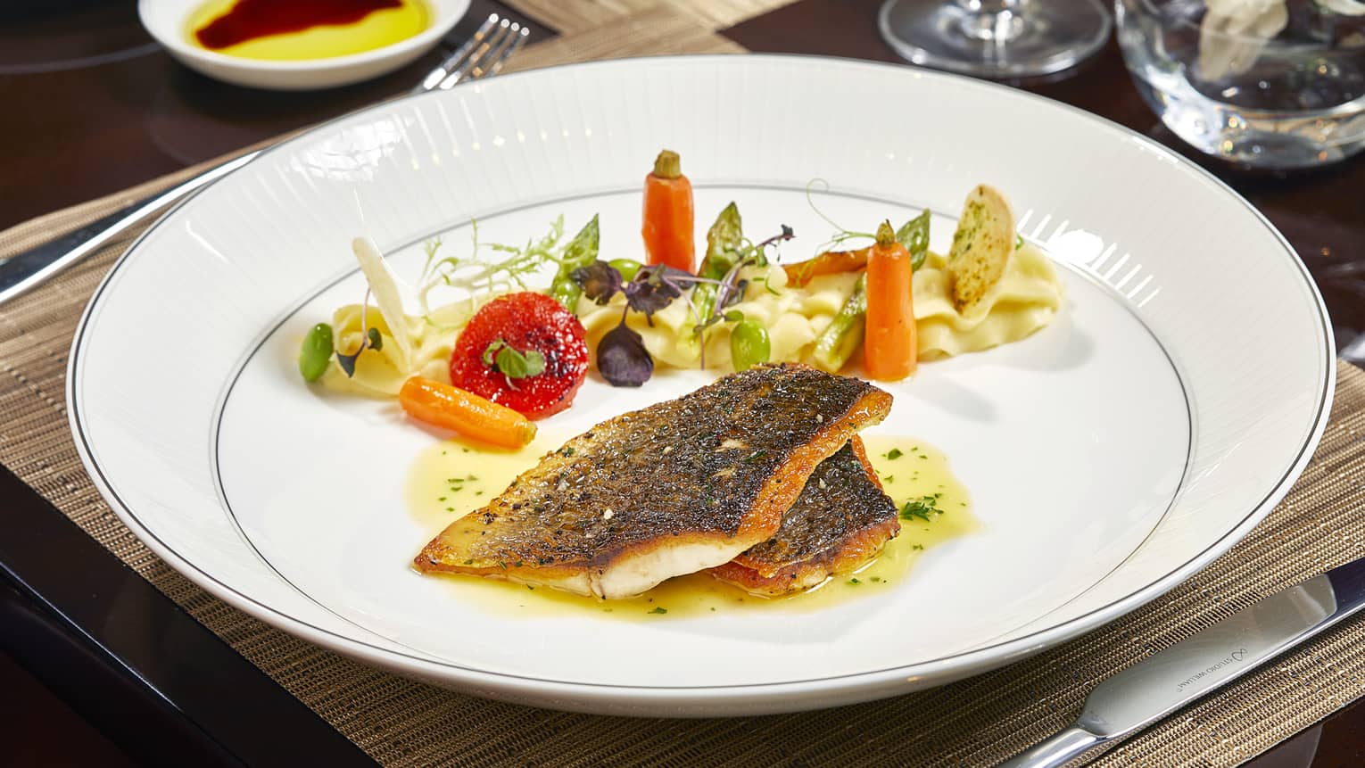 Entree with seared seafood filets, vegetables 
