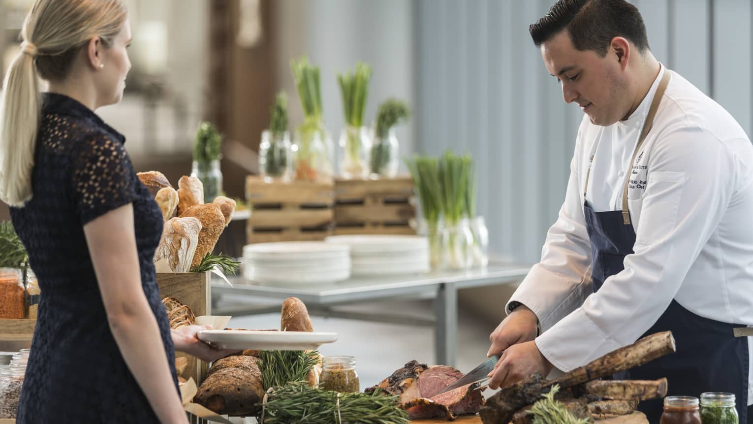 A chef cutting steak for a guest at the Sky Bridge