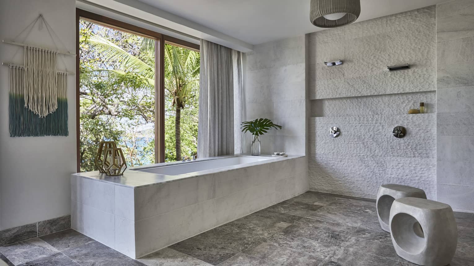 Modern spa room with marble tub under sunny window