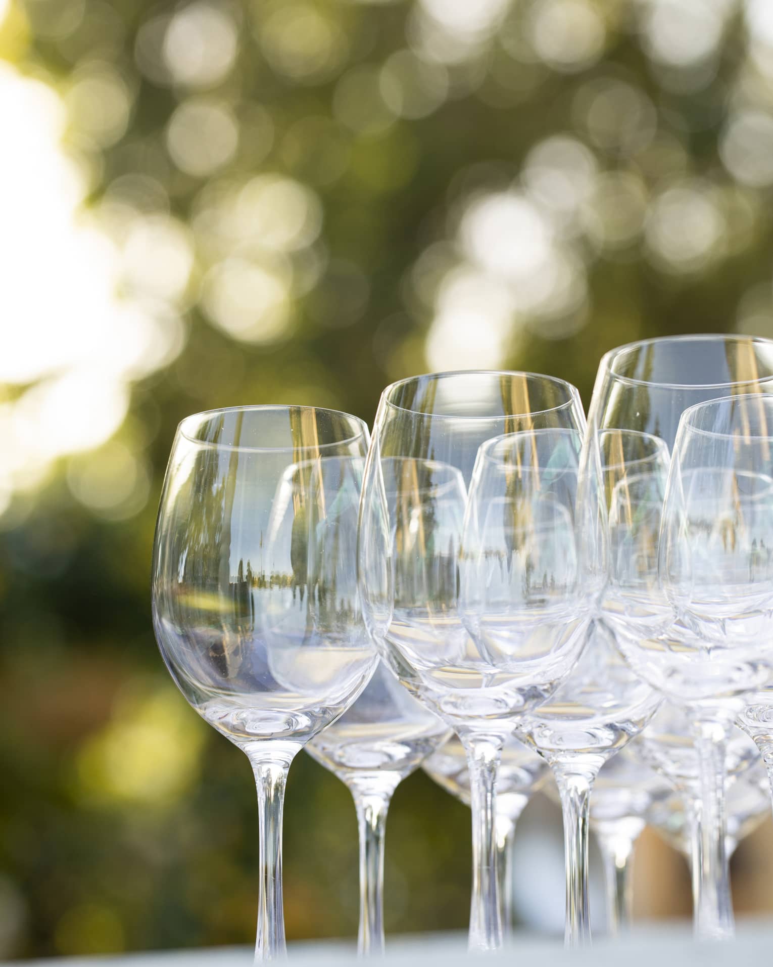 Empty wine glasses grouped together on an outdoor table