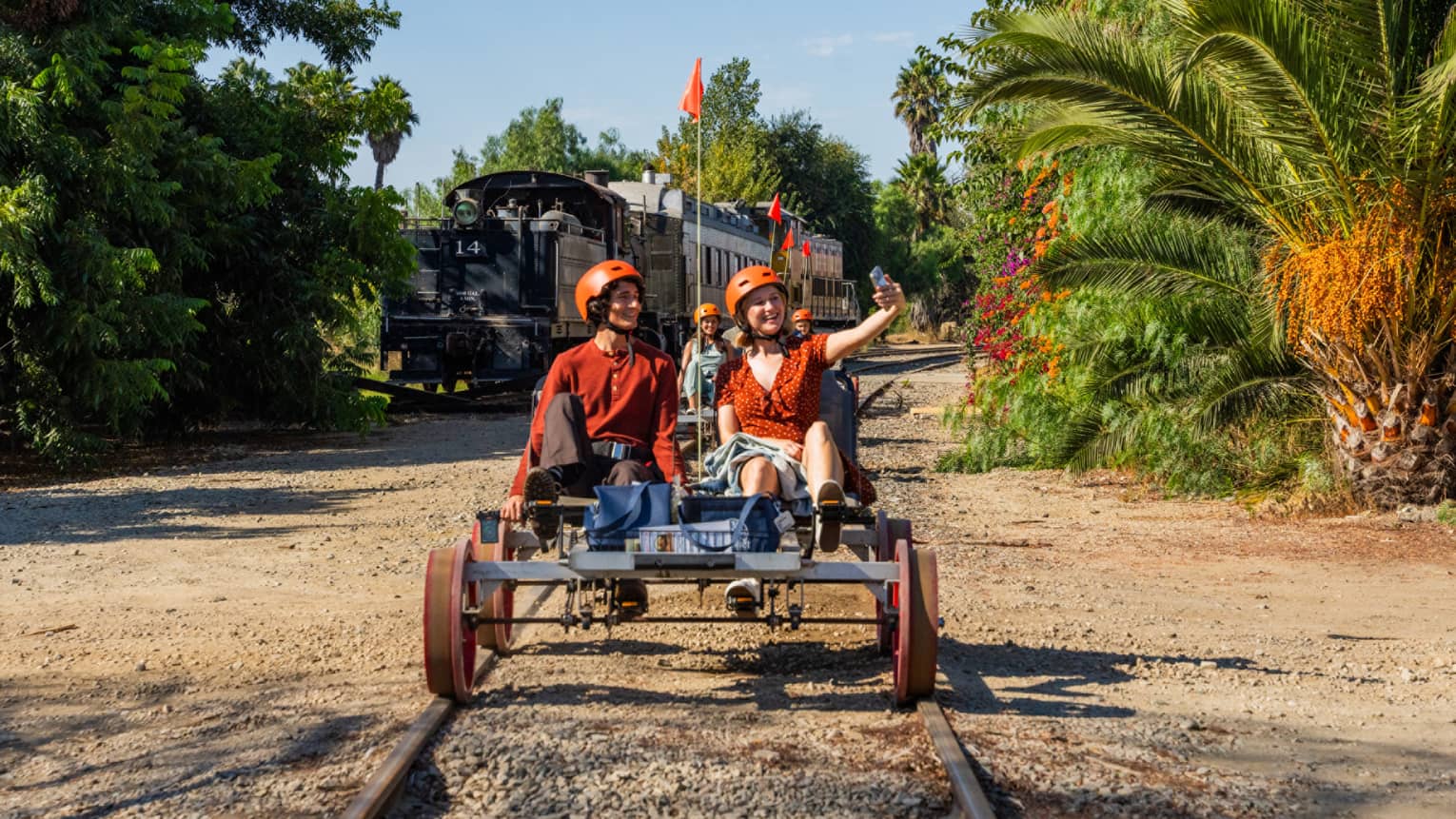 Two guests riding a railbike on a track outside