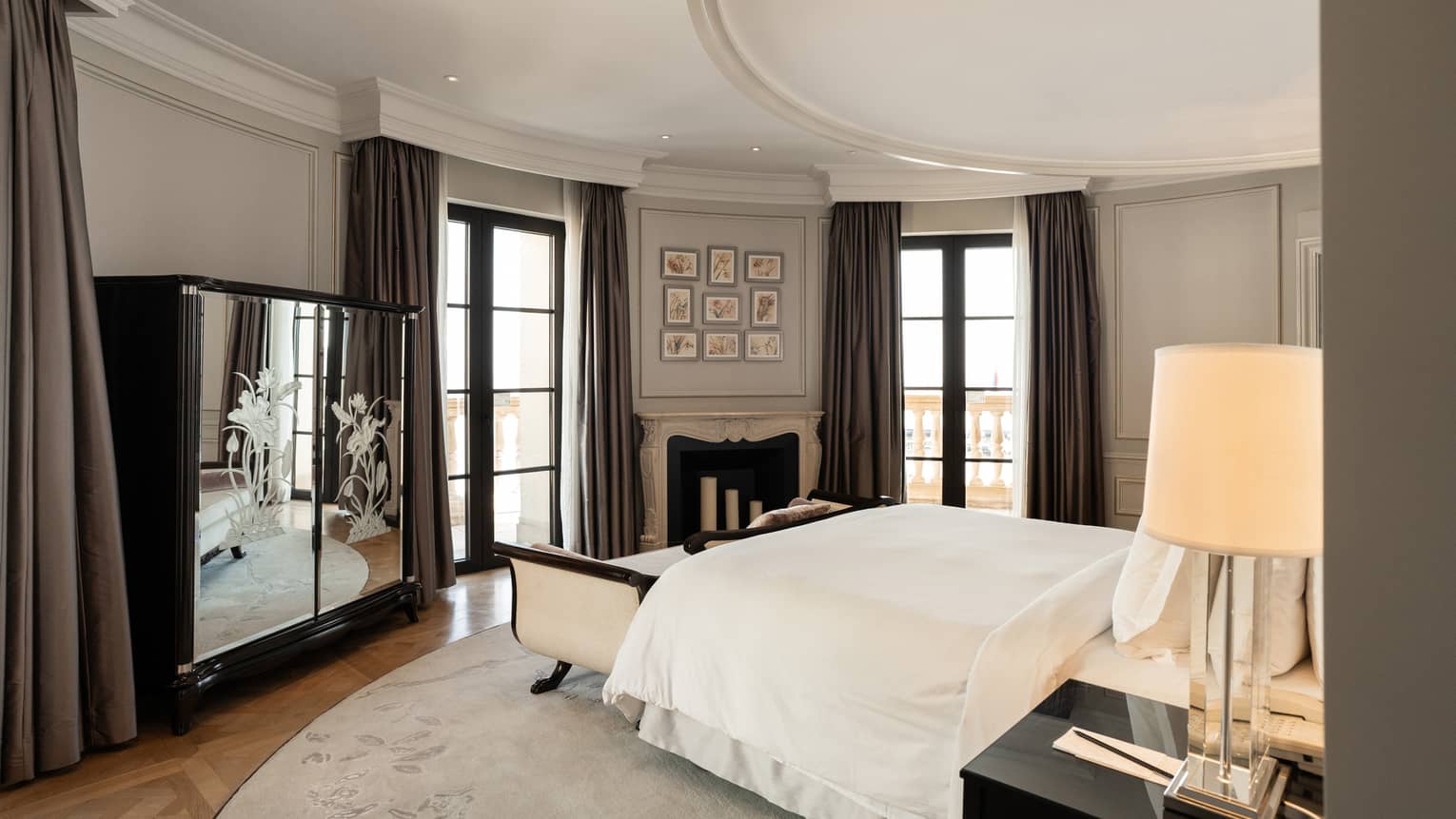 Elegant bedroom with curved wall and walk-out balcony