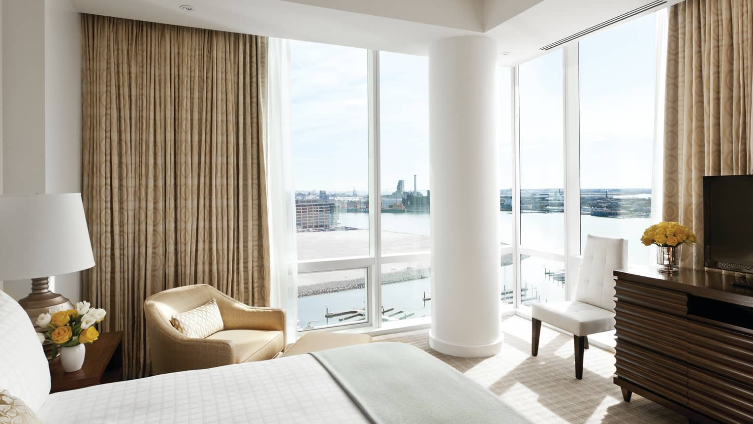 Premium Harbour-View Room of bed with sash, armchair, white pillar on corner window