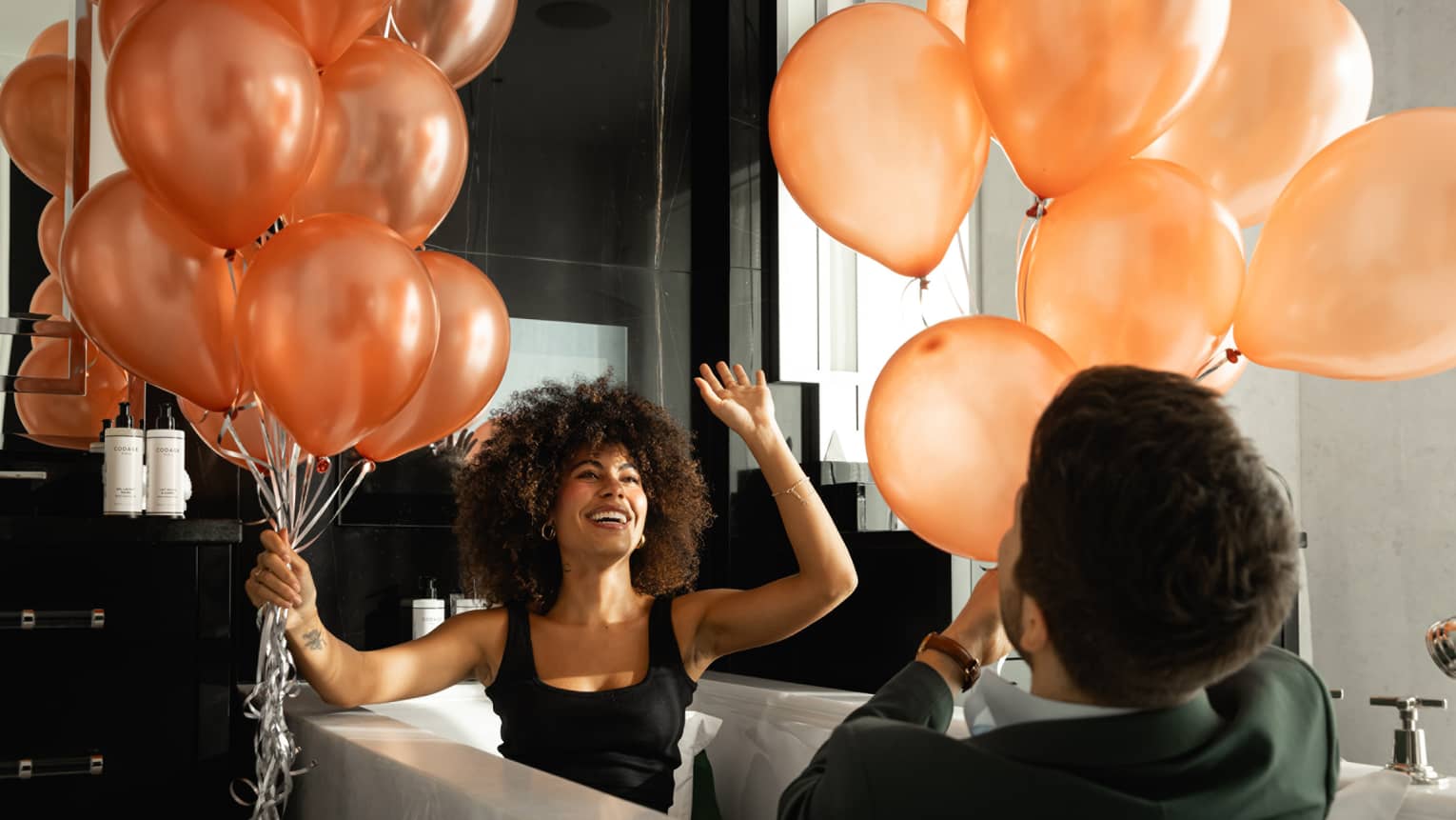 Man and woman playing with balloons