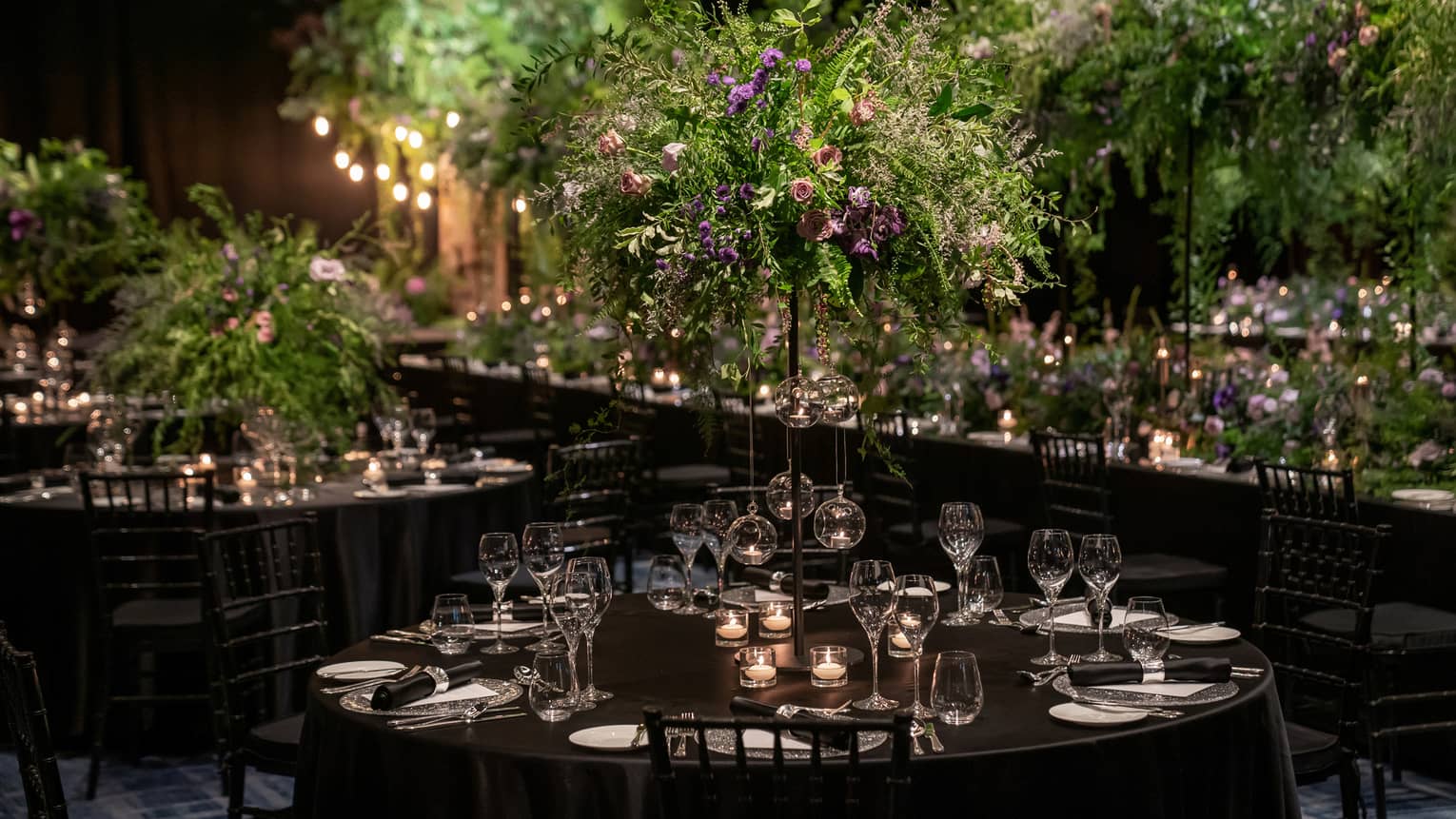 Wedding reception venue with fresh flowers and dark colour scheme