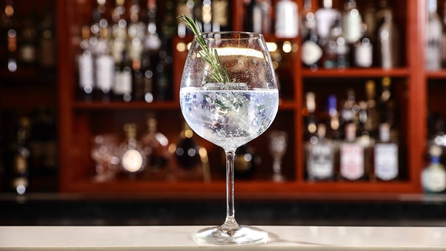 Nordés Gin with Thomas Henry Tonic Water in tall wine glass on bar 
