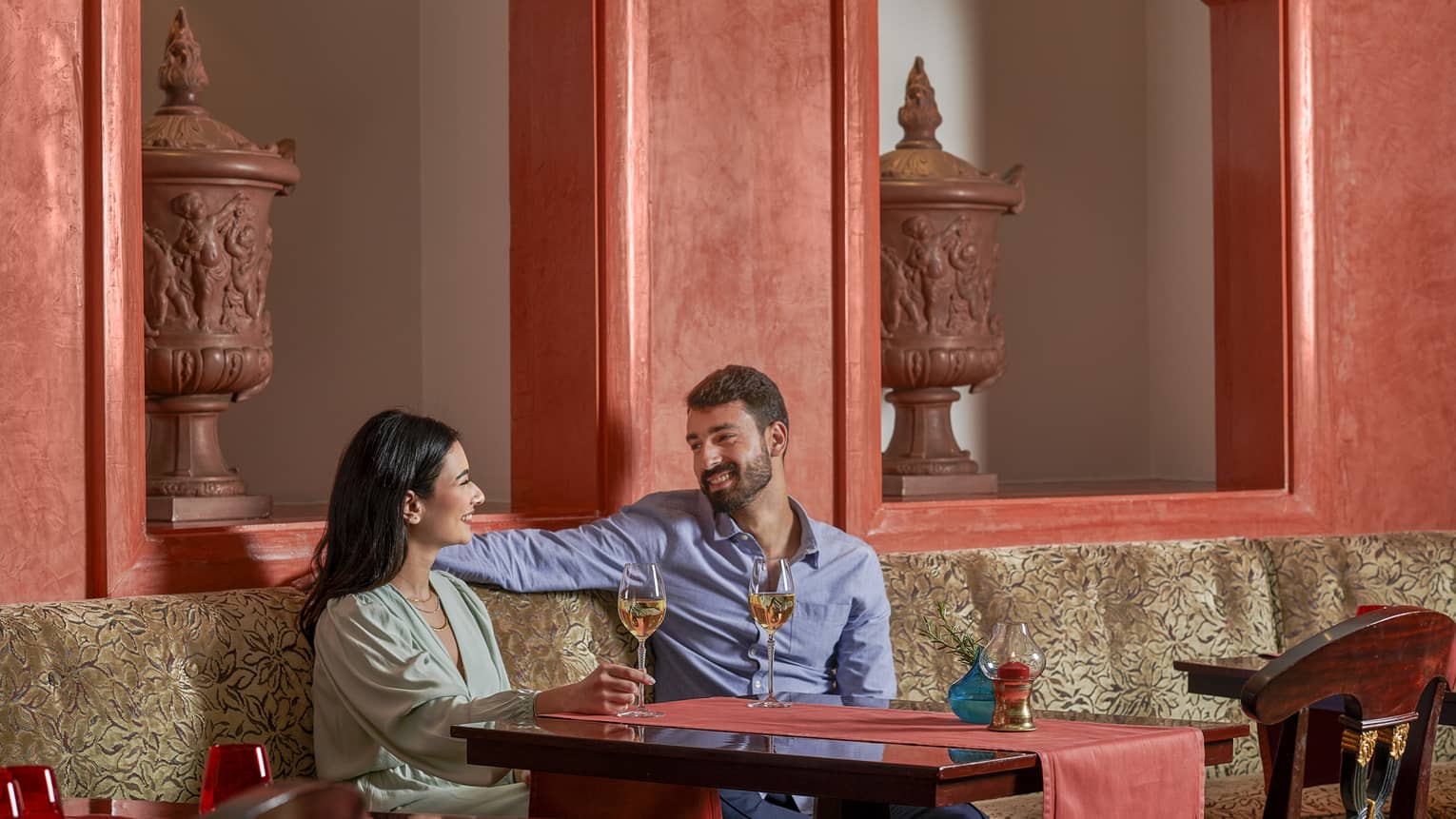 Couple enjoys glass of wine at Stefano's, red accents