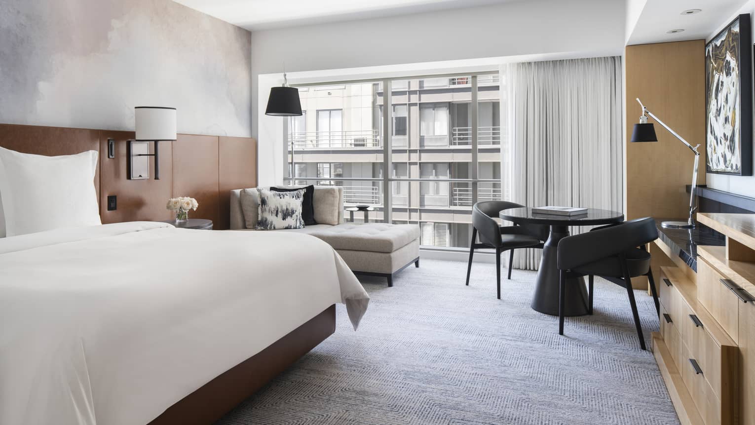 The Partial Bay View Room has a crisply made bed, couch, television, and small table