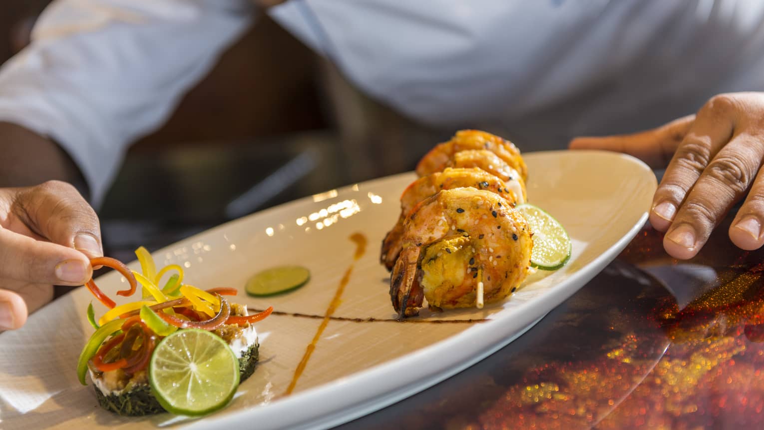 A chef plates some Baraabaru - Malabar Prawns