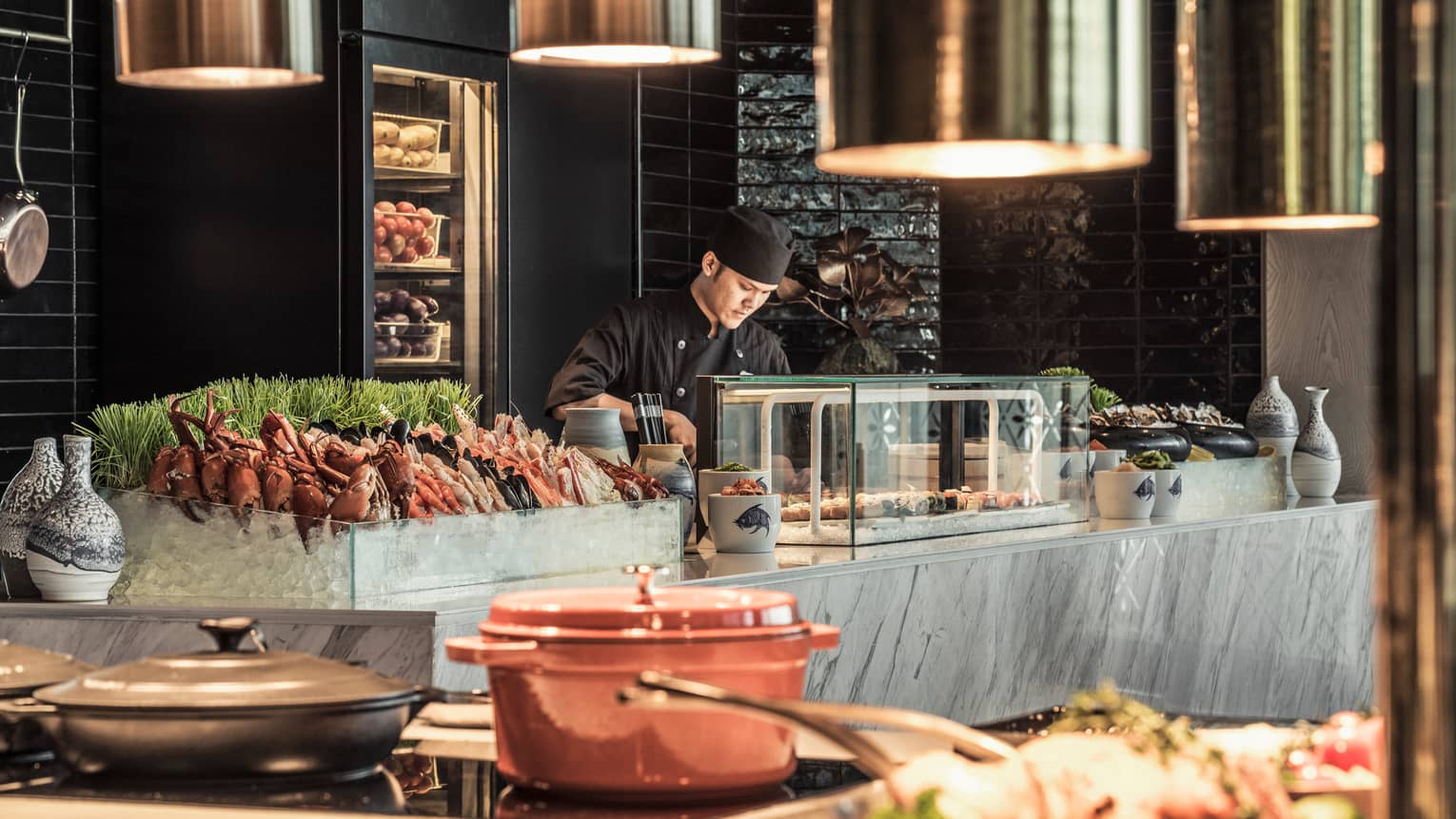 Curate buffet table with server arranging food for guests