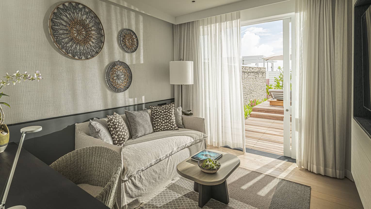 Family Ocean Front Bungalow with Pool living area with couch, door to terrace