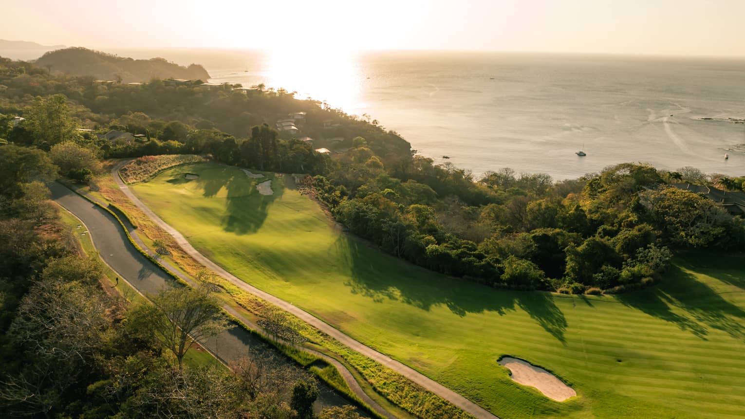 Aerial view of seaside golf course at sunset