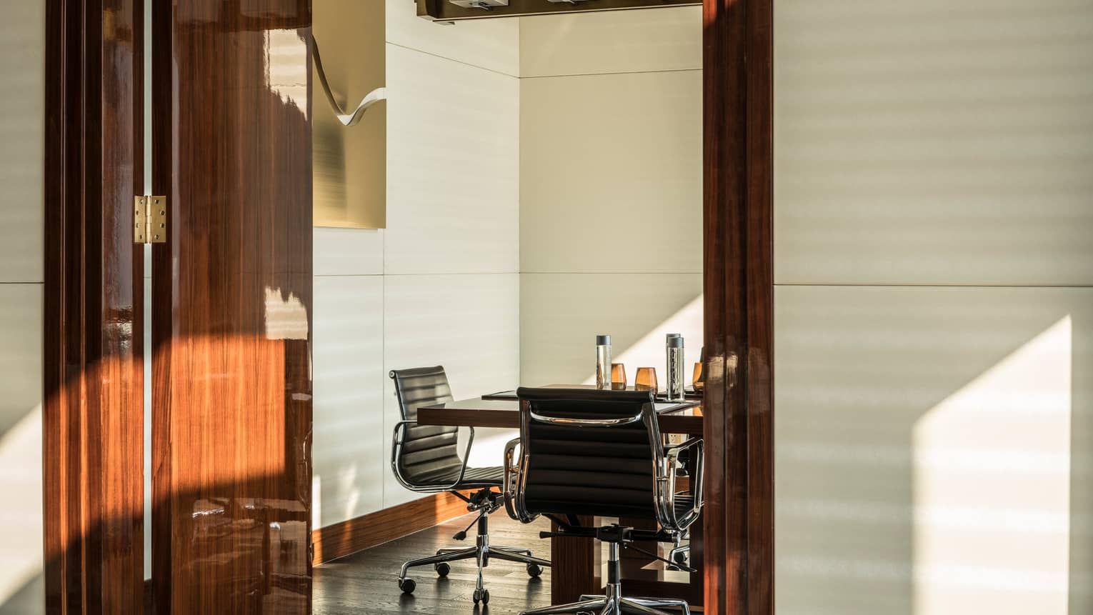 Executive Club Lounge meeting room table, tall wood door