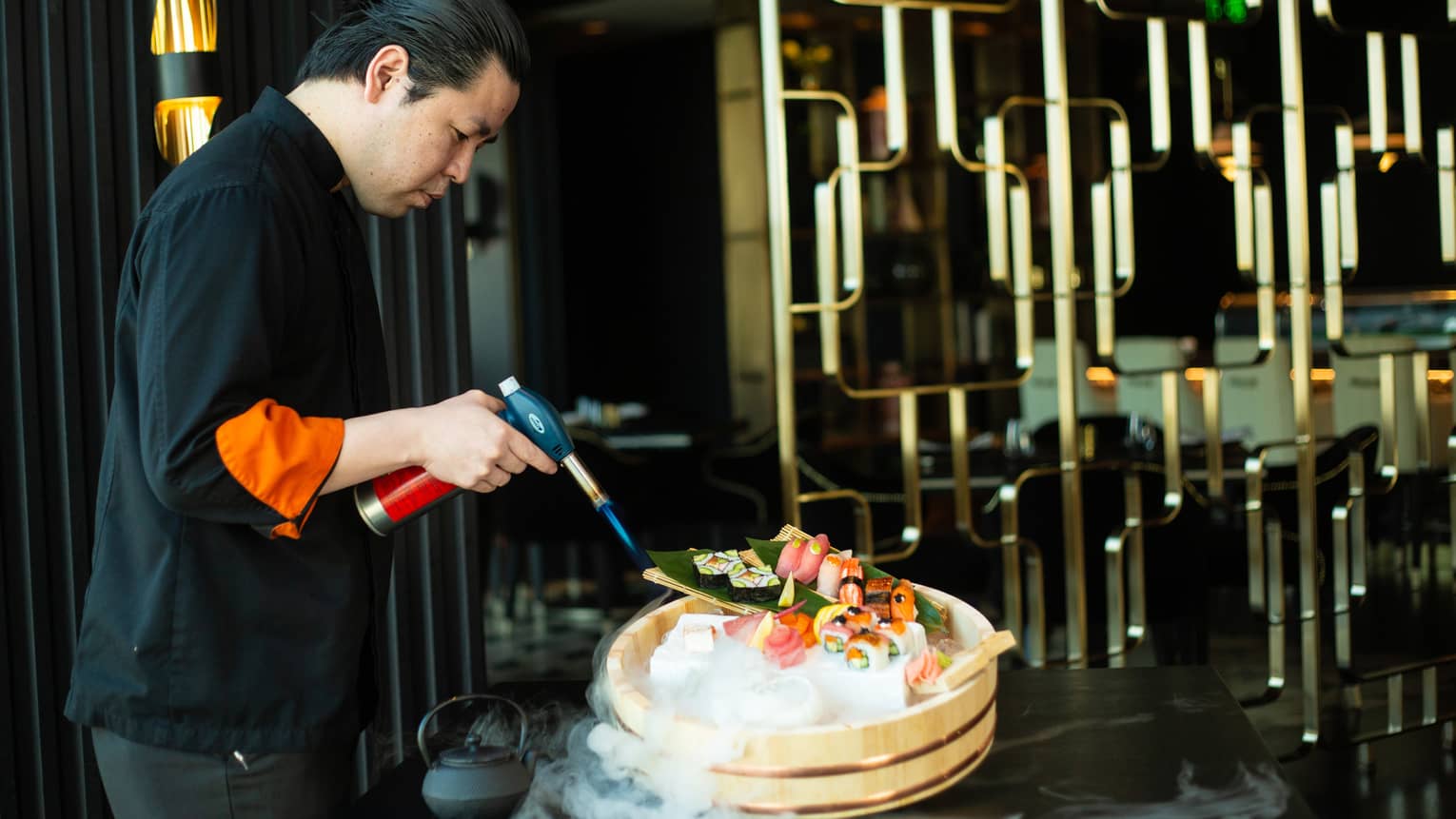 Chef Yonaha uses a torch to put the finishing touches on a signature dish