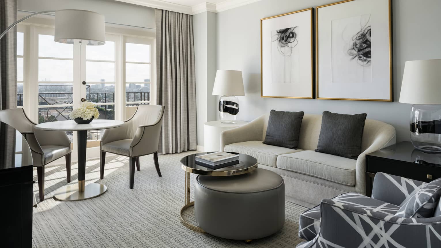 Hollywood Suite grey sofa, armchair, coffee table by cafe table, large window