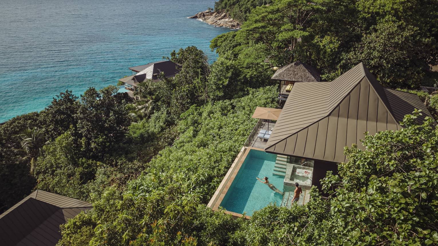 Aerial view of a Residence Villa at Four Seasons Resort Seychelles, overlooking turquoise ocean.