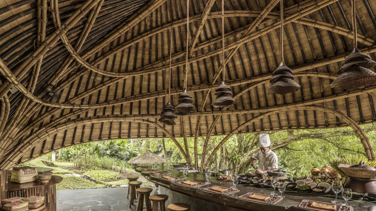 A chef prepares for Sokasi Cooking School in a bamboo pavillion