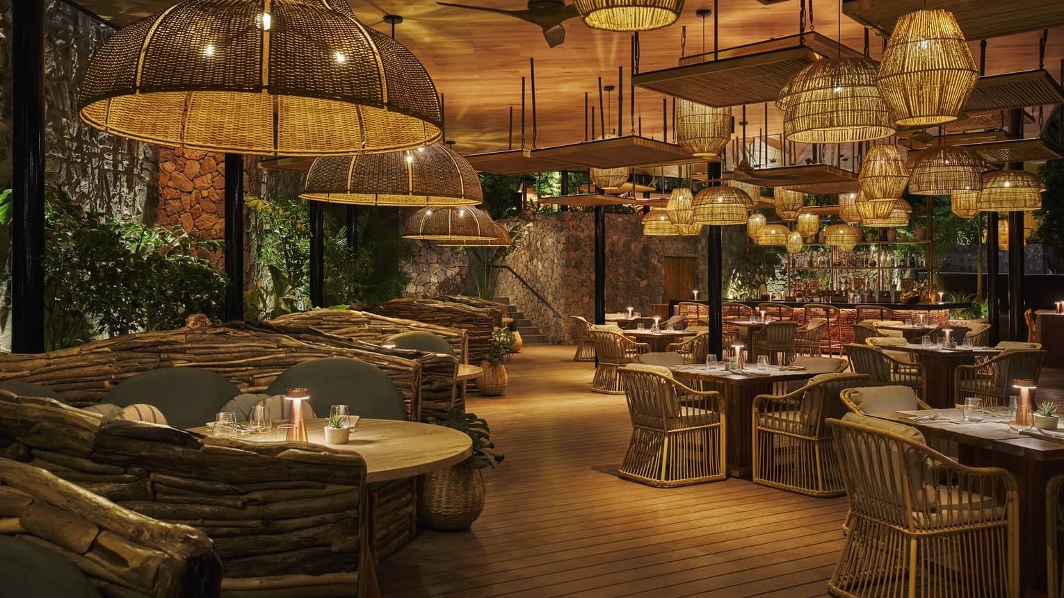 Interior of restaurant dimly lit by numerous rattan overhead lights