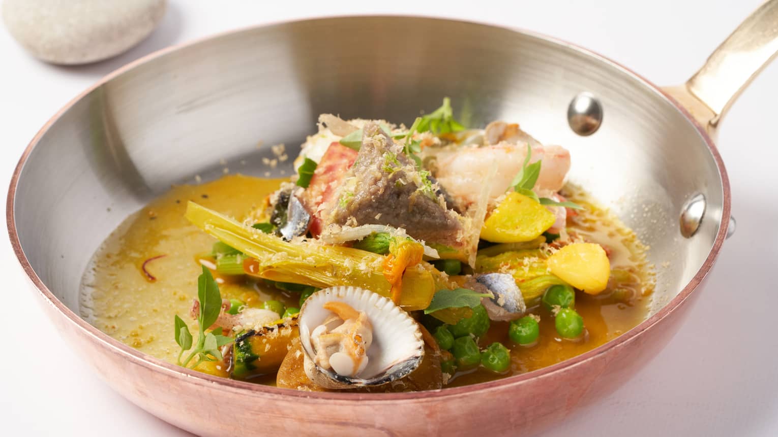 Pan-roasted Mediterranean seafood soup with clams, anchovies and vegetables from the hinterland