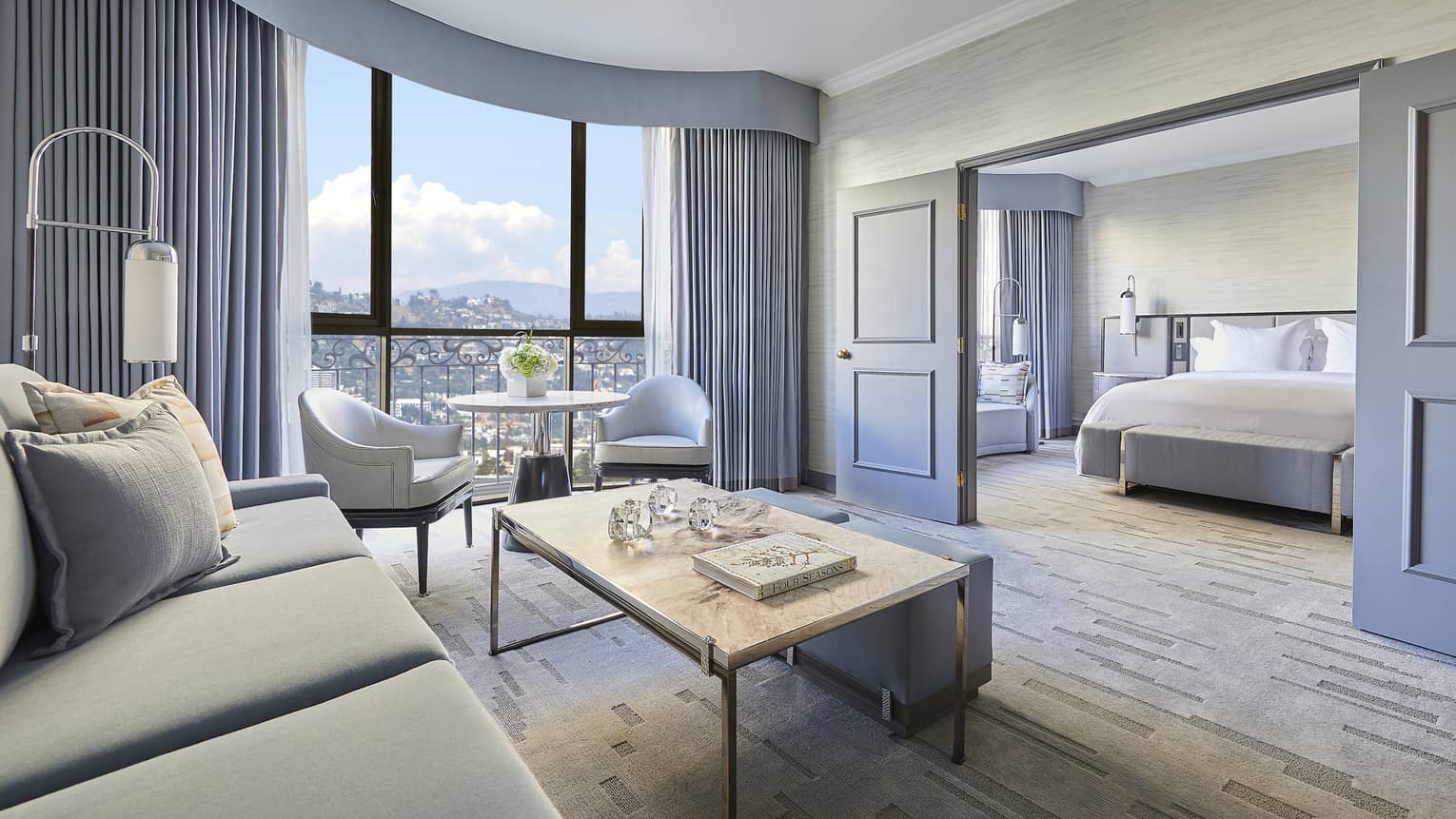 Hotel suite living room with sliding doors to bedroom