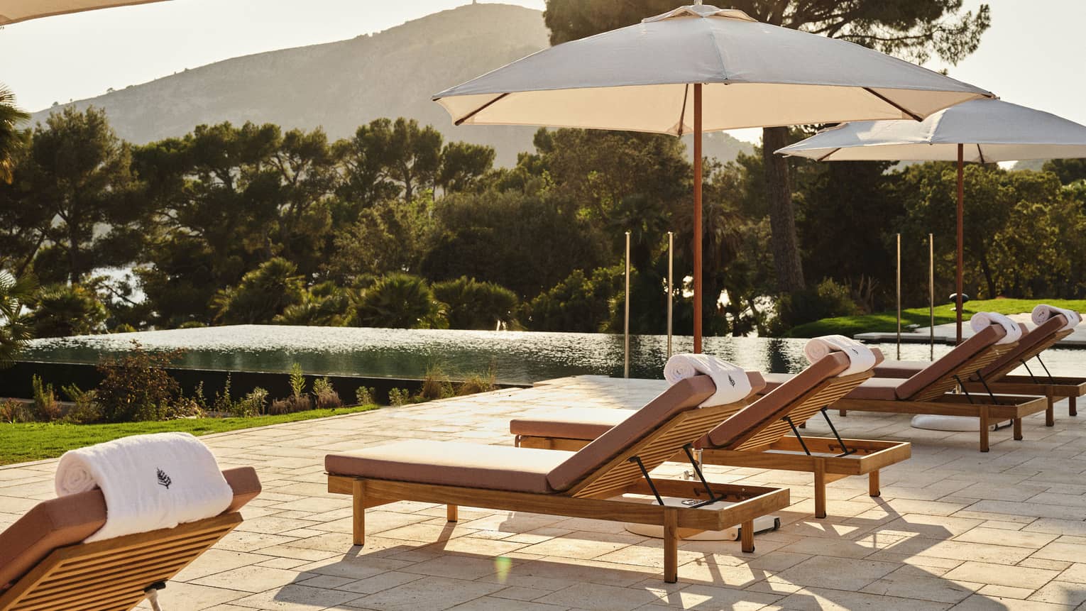 Lounge chairs on a stone pool terrace at Four Seasons Resort Mallorca