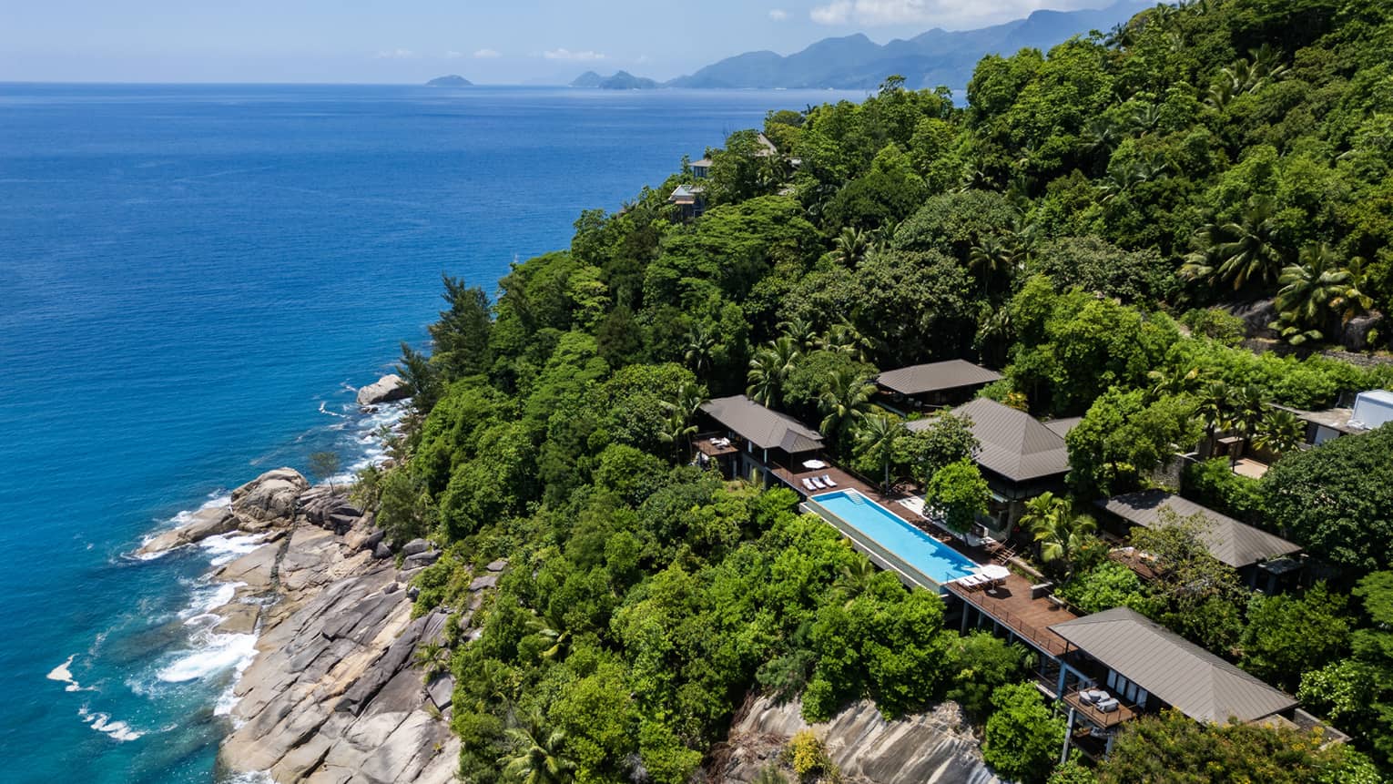 Large private villa on a lush cliff overlooking the sea in tropical location