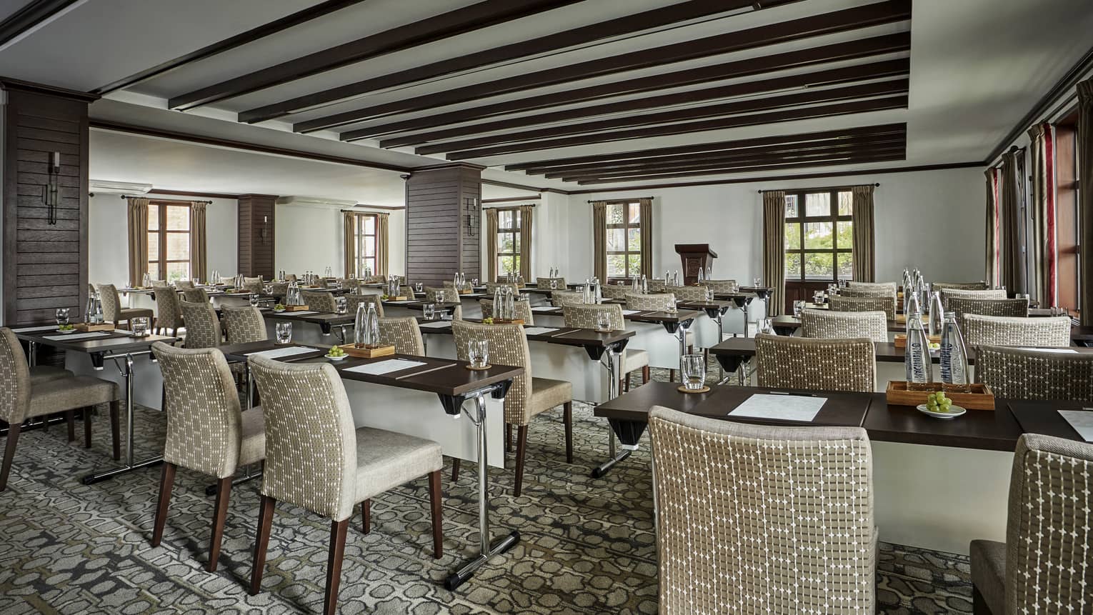 Rows of meeting tables and plush chairs in Casa Medina Ballroom