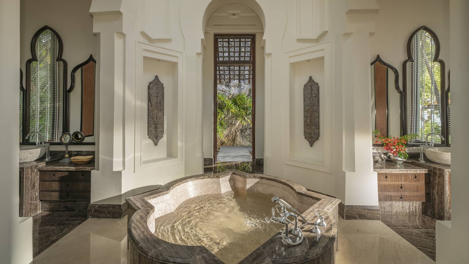Opulent bathroom with intricate crown molding features and standalone tub