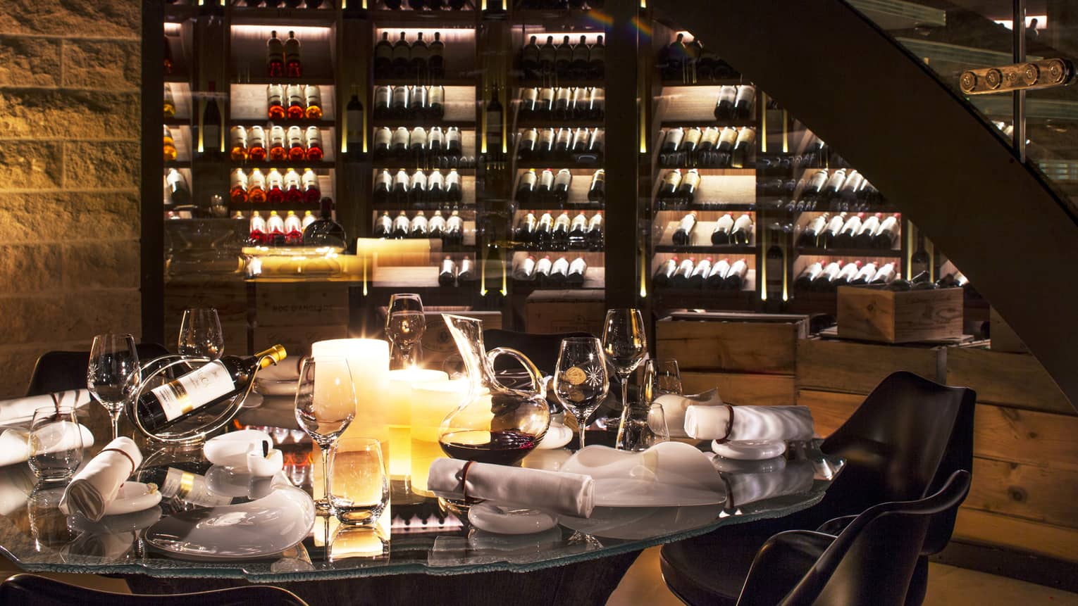 Wine Cellar dining table with bottles of wine, glasses, large candles