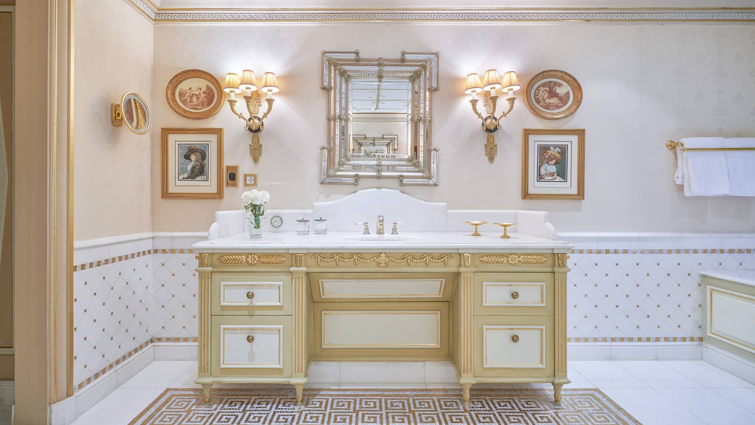 Royal Suite bathroom with single vanity, twin wall sconce lighting. gold accents